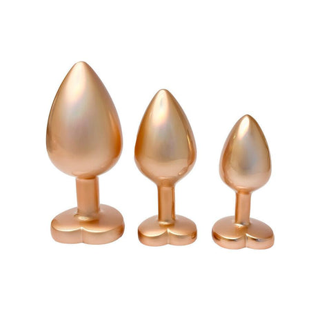 A set of two luxurious gold butt plugs with gleaming pearls 