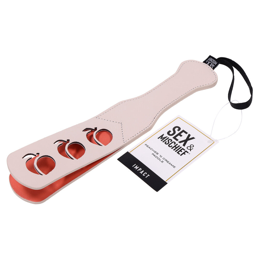 A black leather paddle with red satin lining, perfect for BDSM play