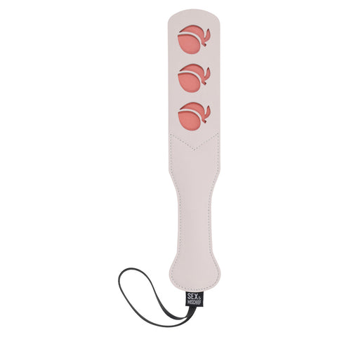 The paddle laying on a bed, ready for a night of kinky fun